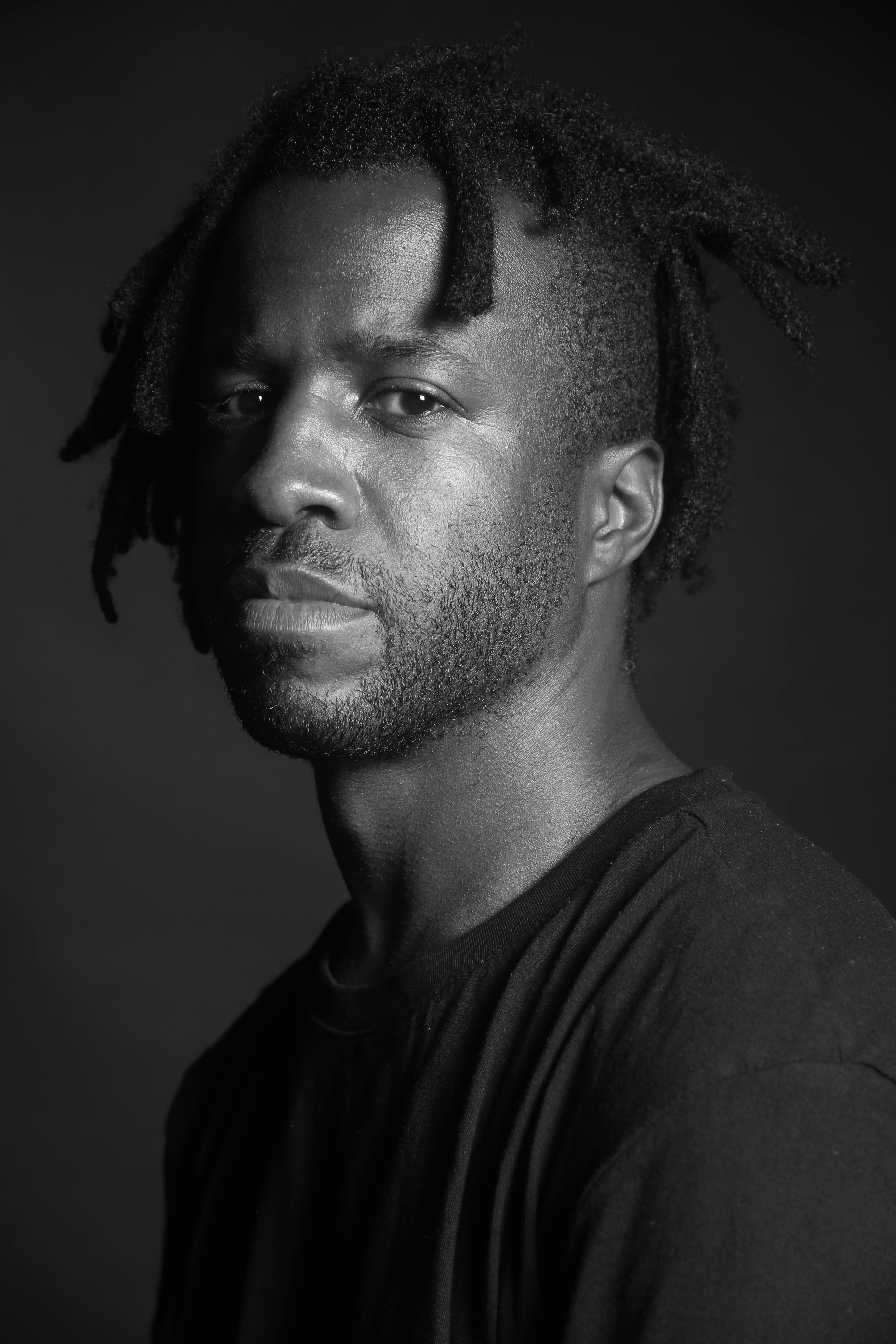 A black and white portrait photo of Simeon Barclay by Ajamu X