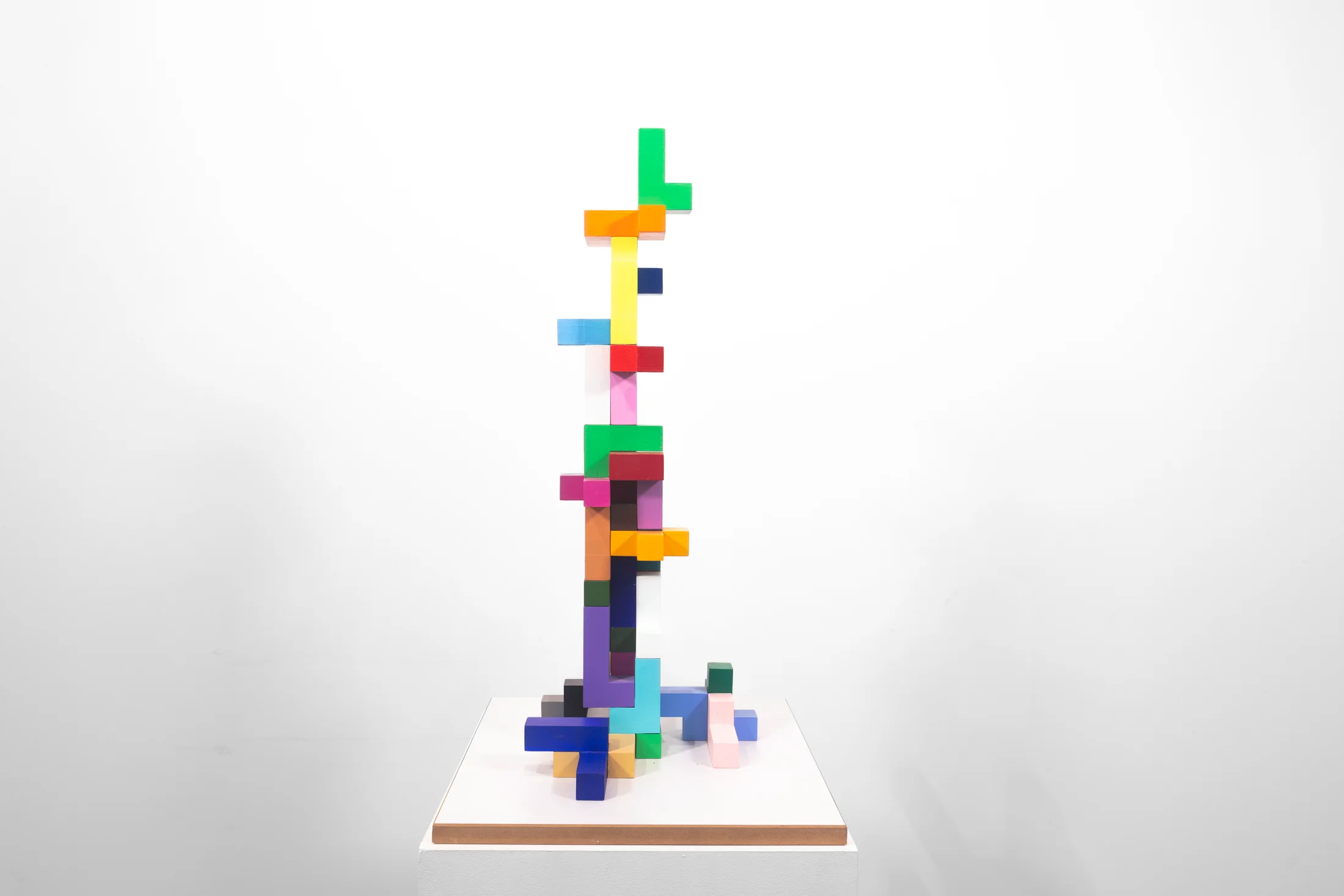 A sculpture by Jacob Dahlgren of multicoloured three-dimensional tetris pieces stacked in a tower