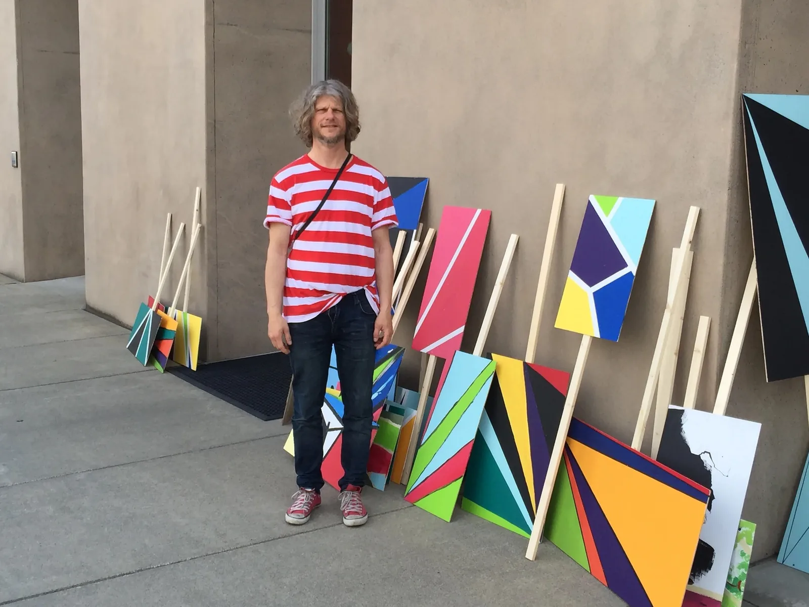 Jacob Dahlgren standing in front of abstract signs