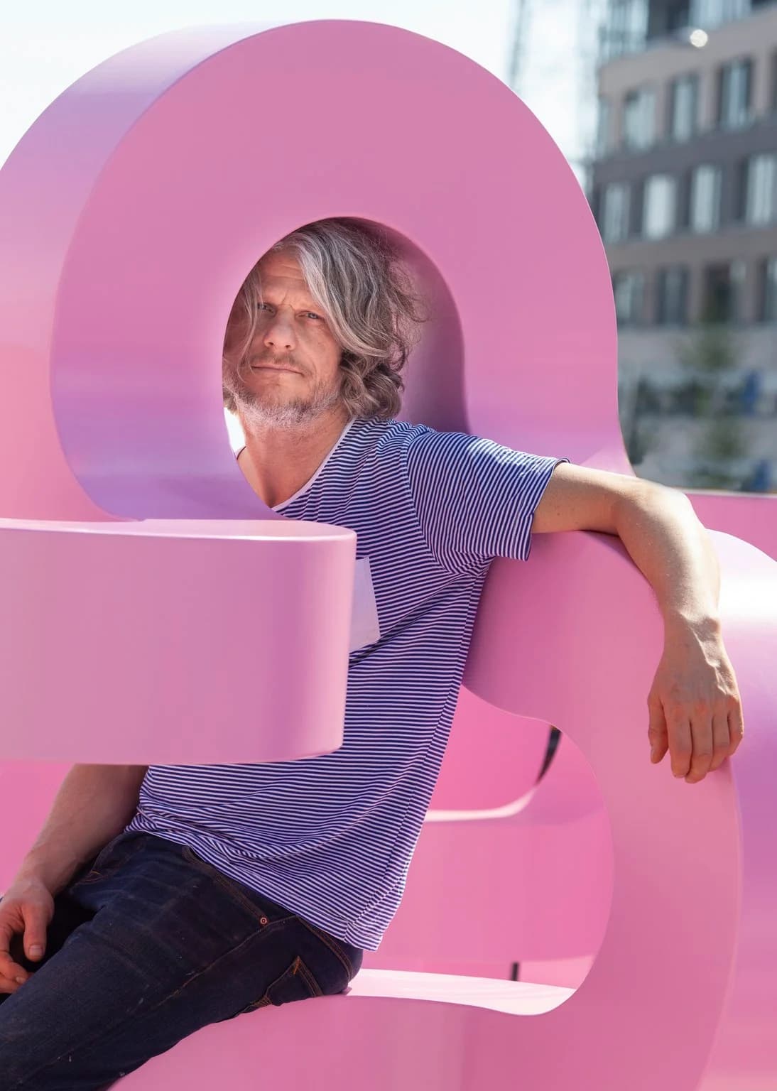 Jacob Dahlgren sat within his metal pink sculpture