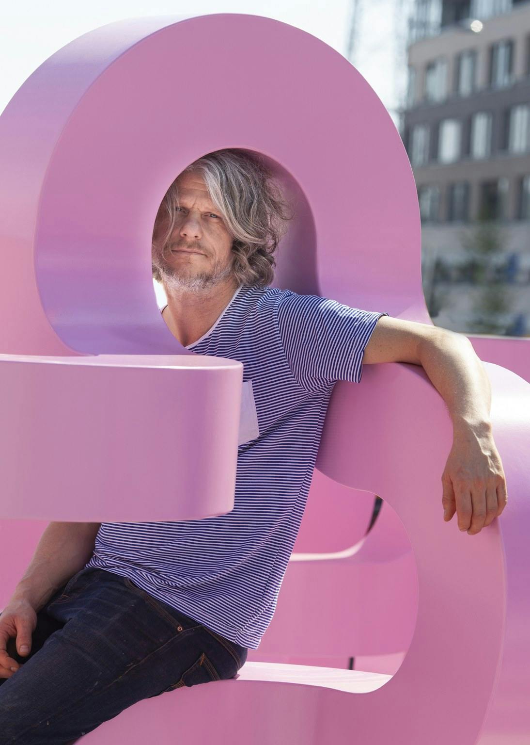 Jacob Dahlgren sat within his metal pink sculpture