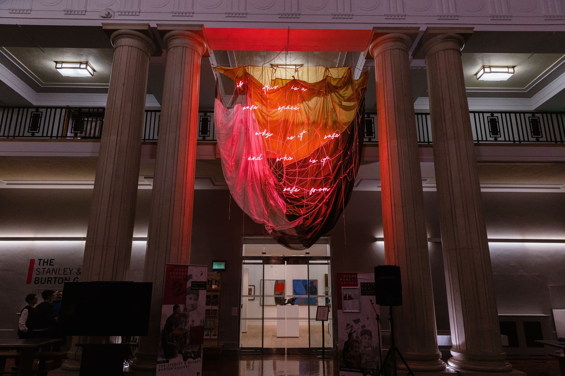 A neon and parachute hanging sculpture by Simeon Barclay